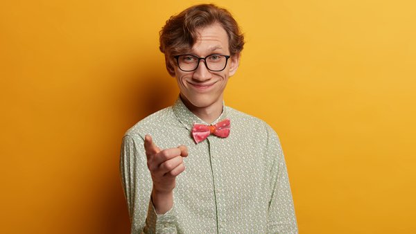 positive-handsome-smiling-man-indicates-at-you-points-with-index-finger-directly-wears-fashionable-shirt-selects-someone-wears-glasses-poses-over-yellow-wall-you-should-join-me